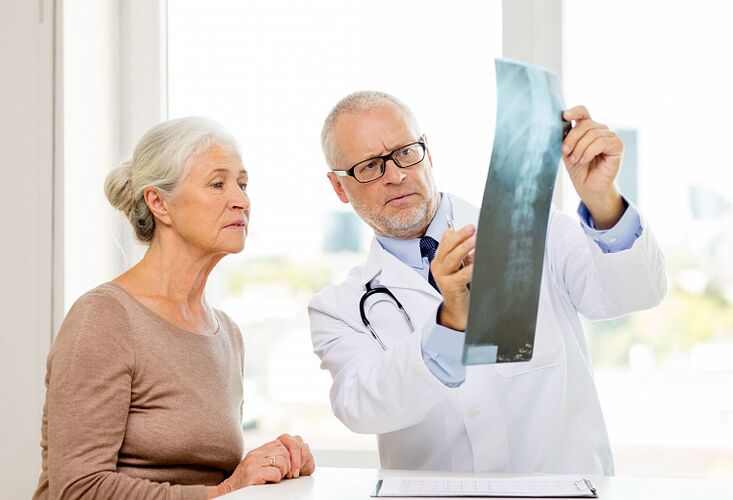 A doctor determines cervical osteochondrosis in a patient using X-rays